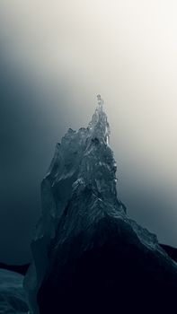 A striking ice formation captured against a moody grey sky, showcasing the beauty of frozen nature.