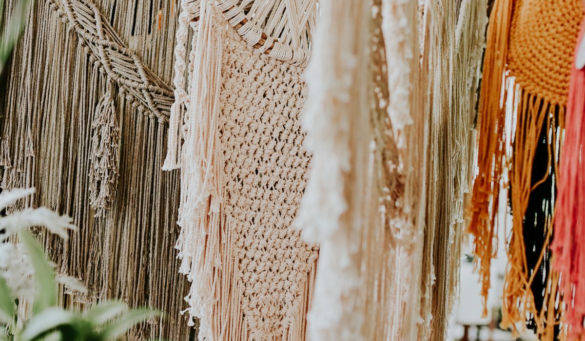Handmade macrame wall hanging showing cotton cord knotting detail in a bohemian interior