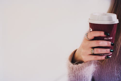 Free Person With Black Manicured Nails Holding Brown Cup With White Lid Stock Photo