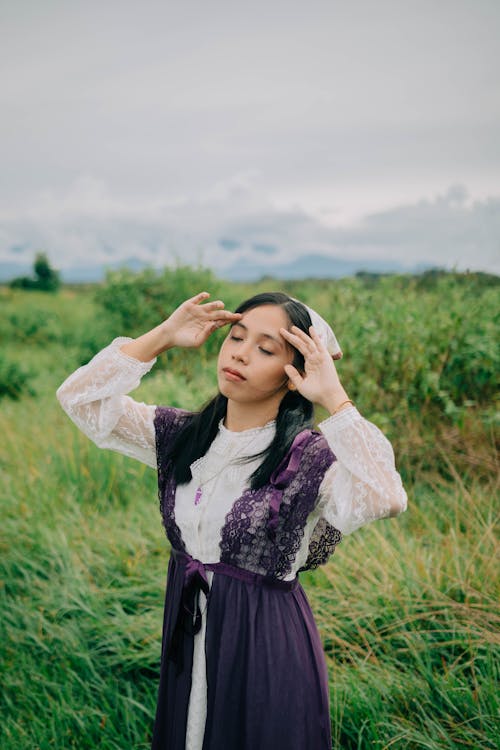 Free A Woman in Lace Dress Wearing Bandana while Posing on a Grass Field Stock Photo