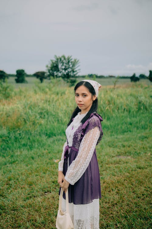 Free Woman Wearing Lace Dress Standing on Green Grass Field  Stock Photo