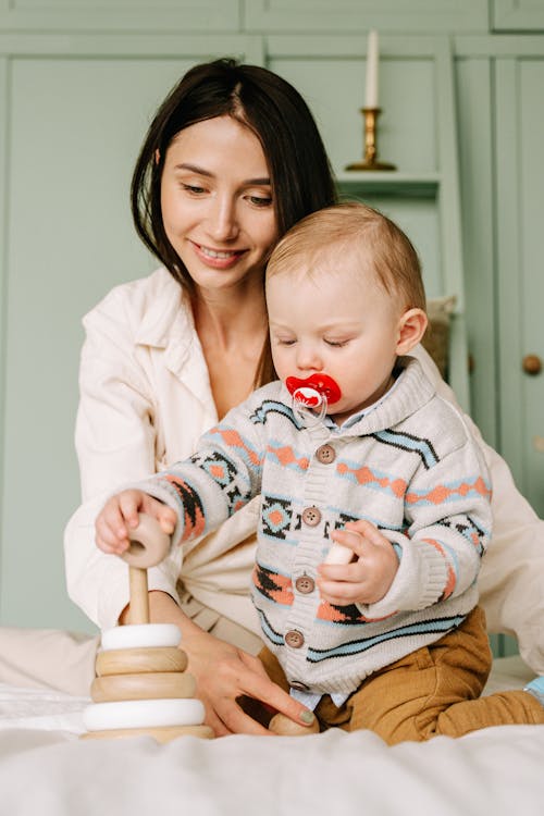 A Baby Playing Wooden Toys