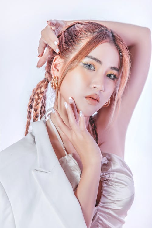 Close-Up Shot of a Pretty Woman in White Top Posing