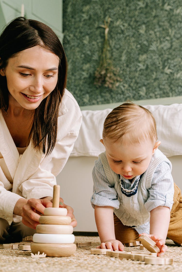 Mother And Baby Boy Playing With Wooden Toys