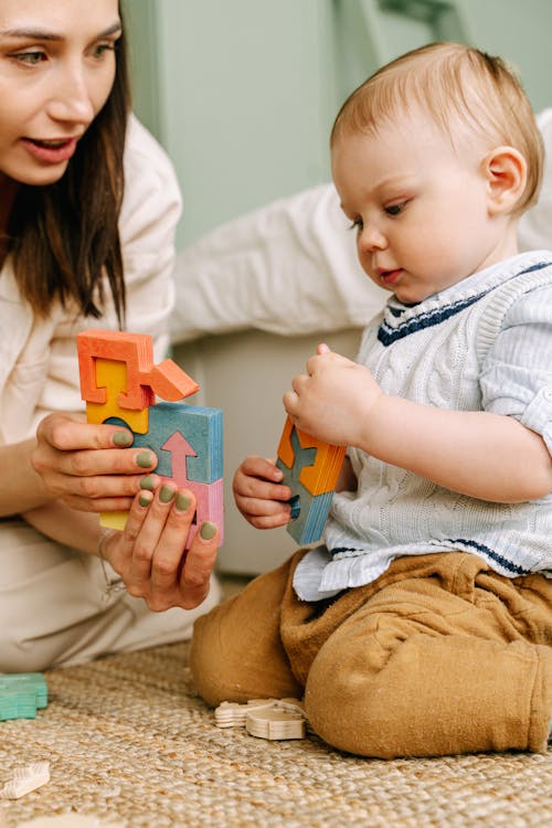 A Baby Playing Wooden Toys