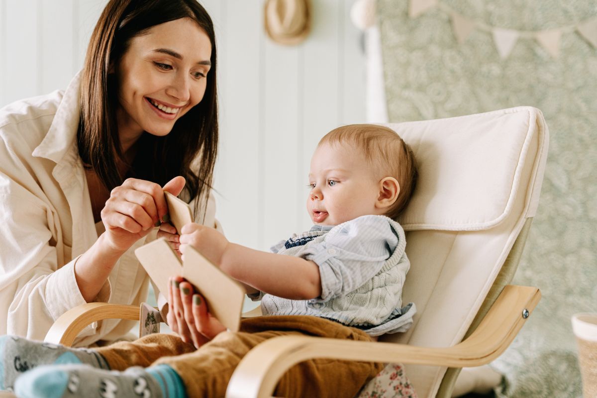 Infant exploring an educational activity with an adult