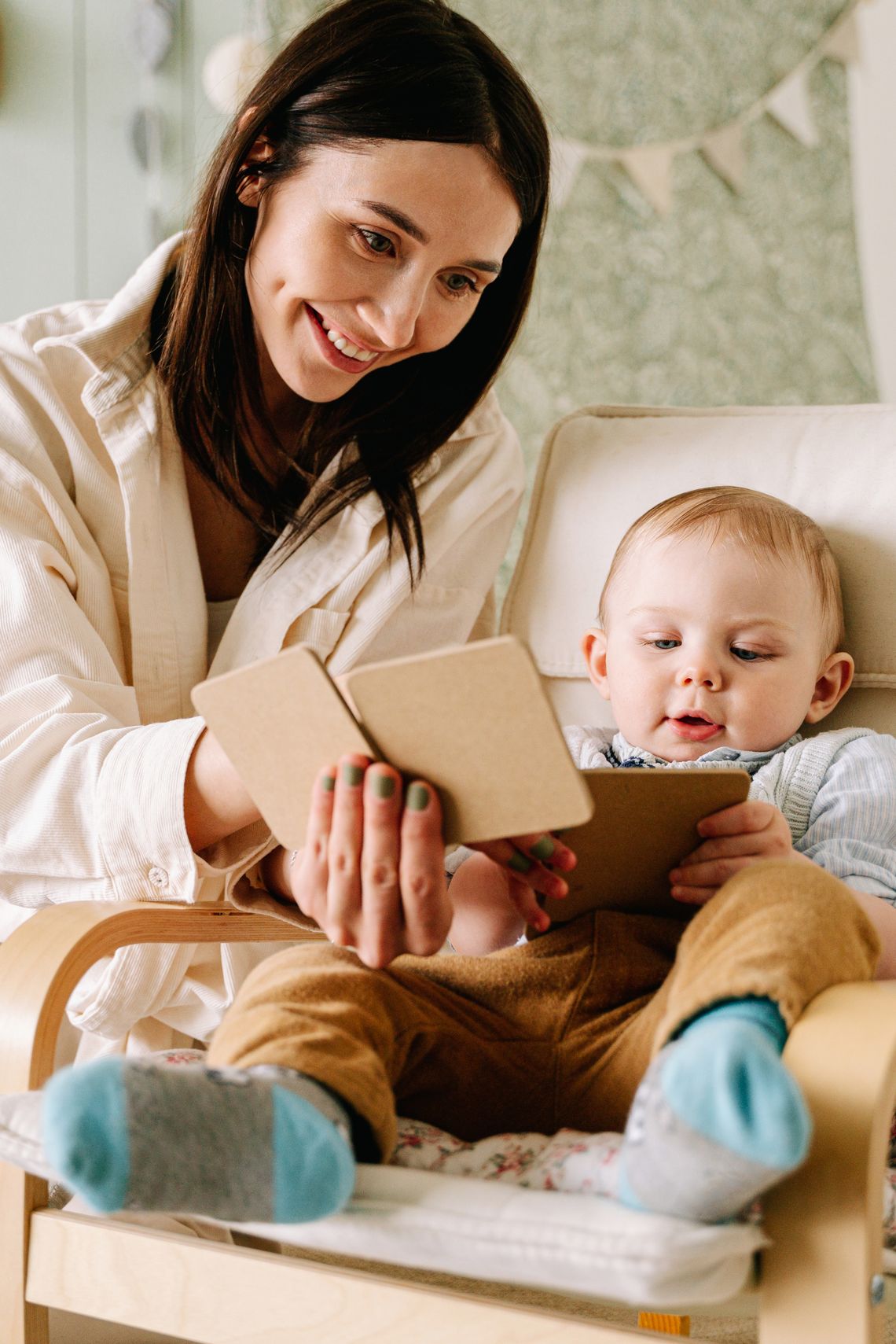 Mother and toddler enjoying a wooden learning activity together at home