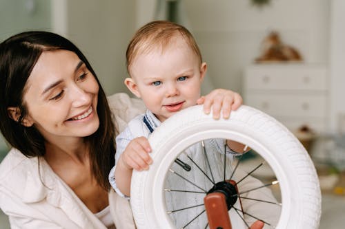 Portrait of Woman in White Dress Shirt with Baby Boy