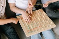 Close-Up Photo of Kids Playing Geoboard