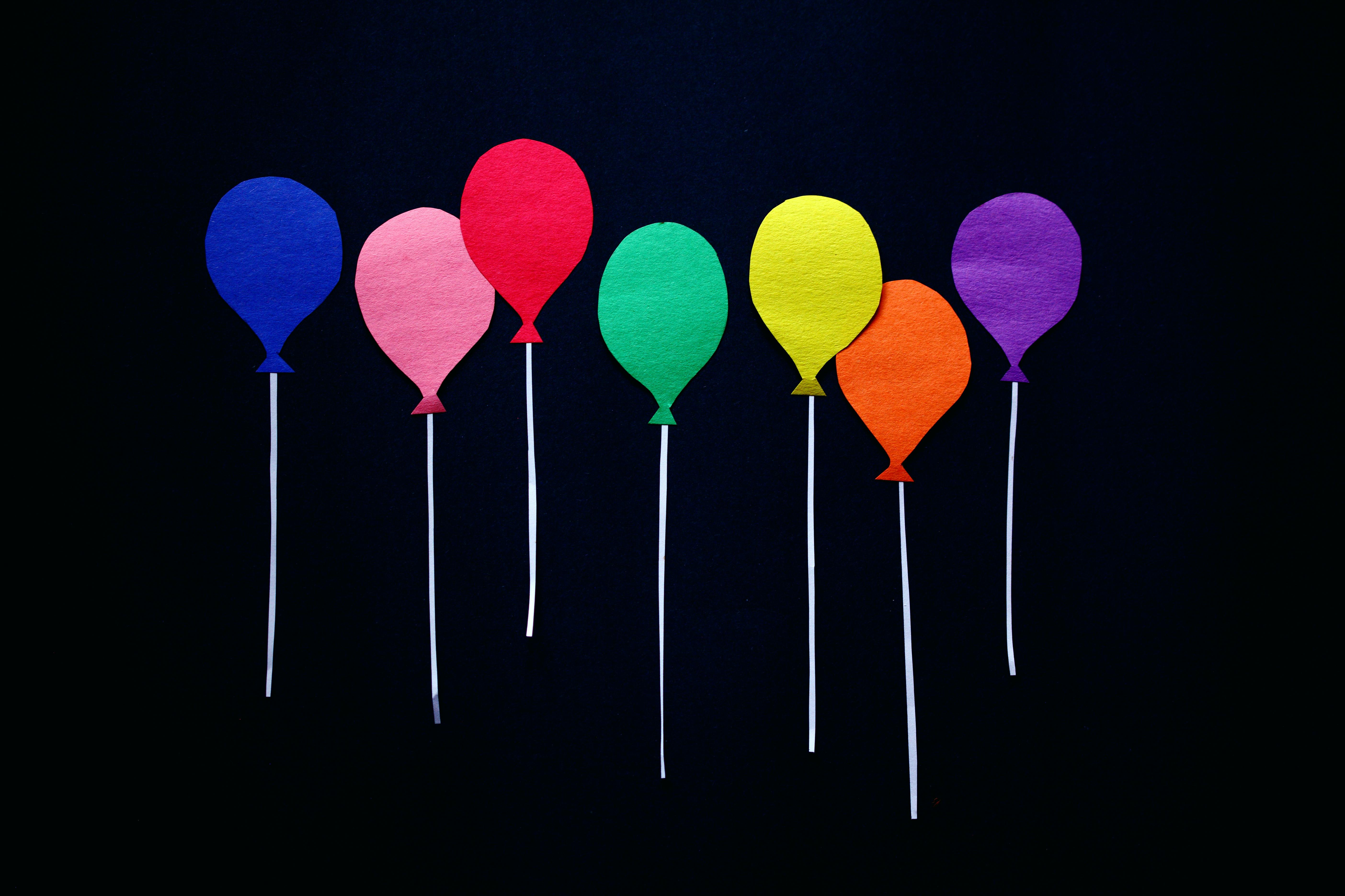 Colorful Cutout Balloons on Black Background · Free Stock Photo