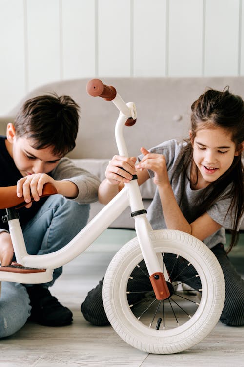 Boy and Girl Holding White Bicycle