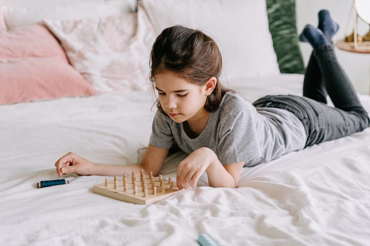 Young Girl Playing A Board Game