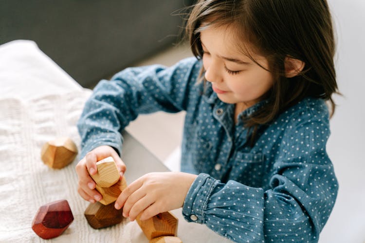 A Girl Playing Wooden Blocks