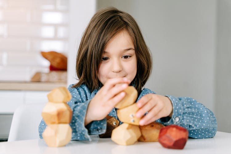 A Girl Playing Wooden Blocks