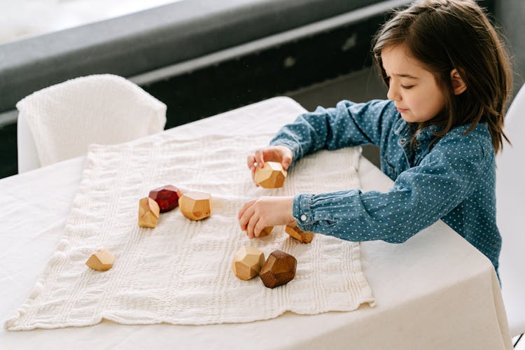 A Girl Playing Wooden Blocks