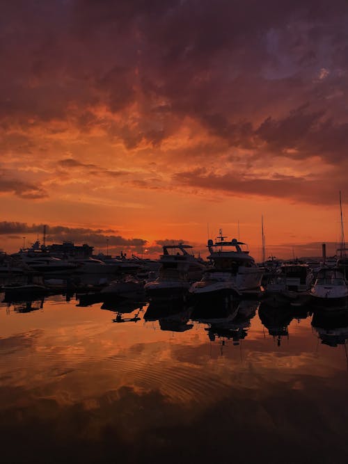 Silhouette of Boats on Water during Golden Hour