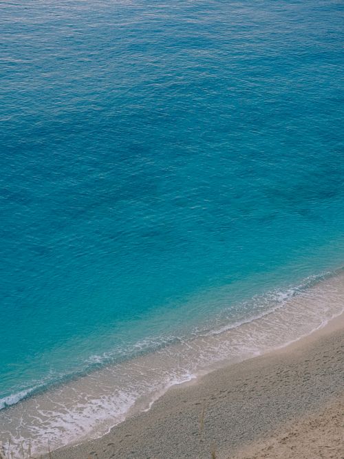 Free Discover the tranquil beauty of Antalya's coastline with crystal-clear blue waters meeting sandy shores from an aerial perspective. Stock Photo