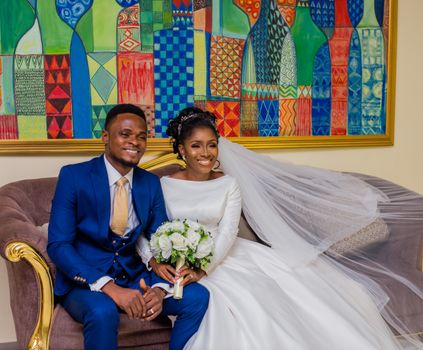 A Newlywed Couple Sitting on Couch