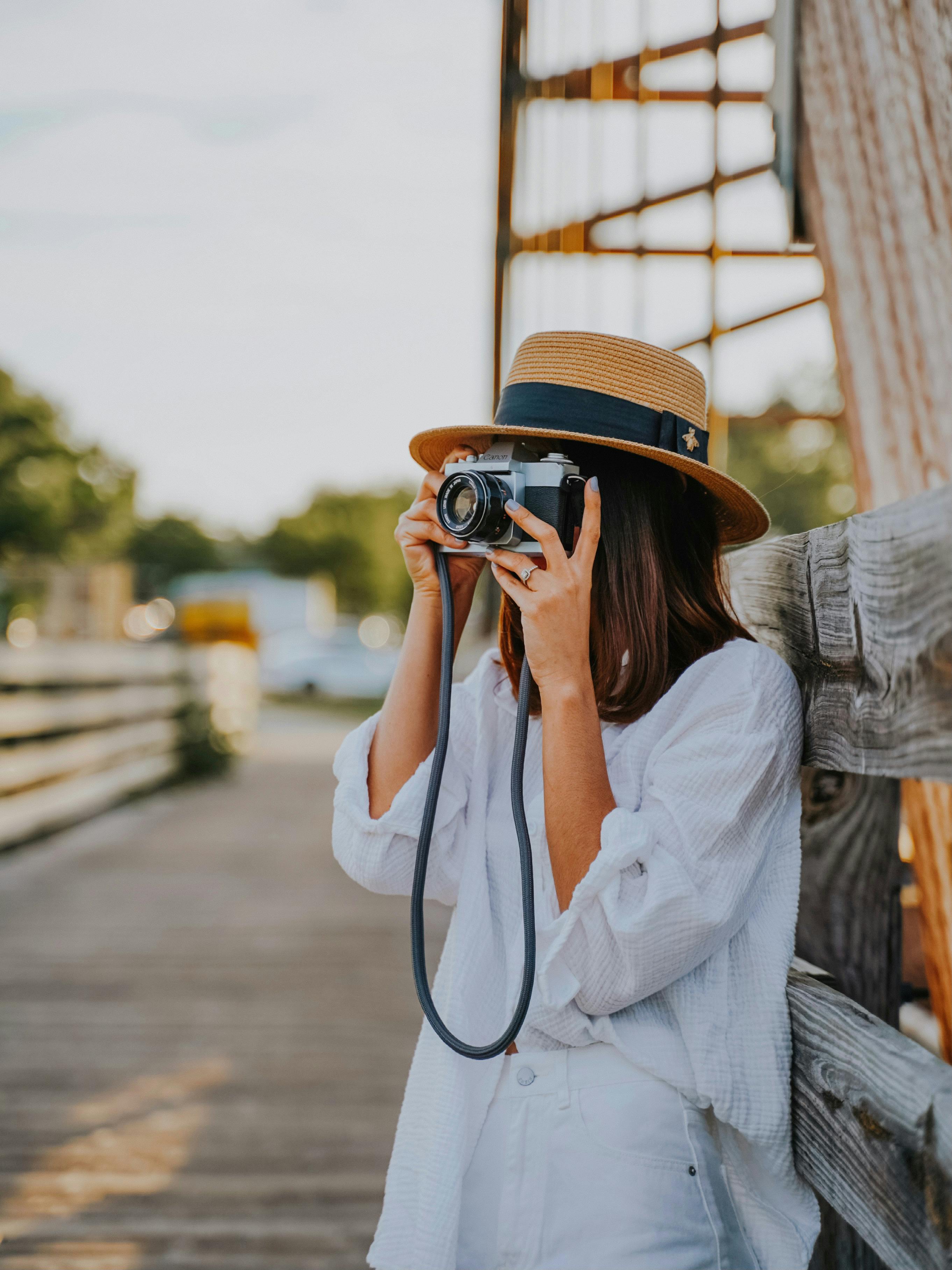 shallow focus photo of woman taking photos using a digital camera