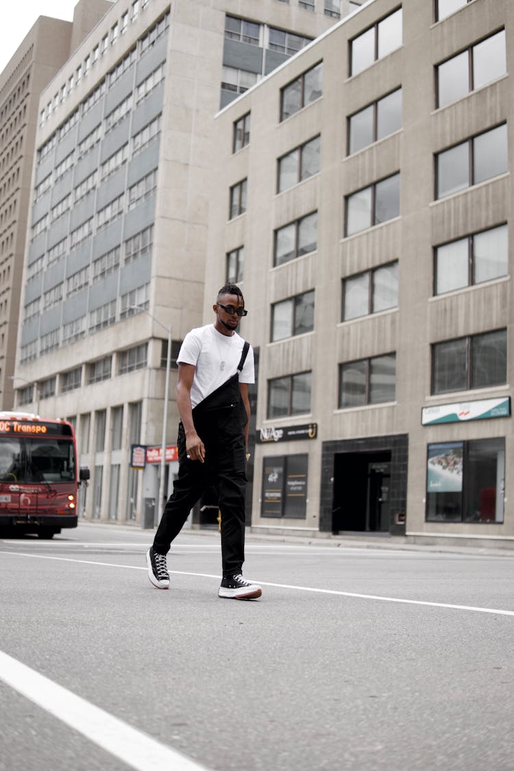 A Fashionable Man In Streetwear Walking On The Street