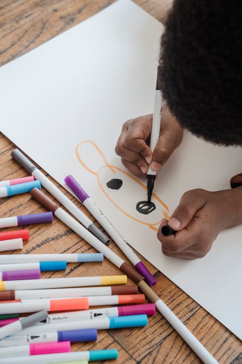 A Boy Drawing on a Paper