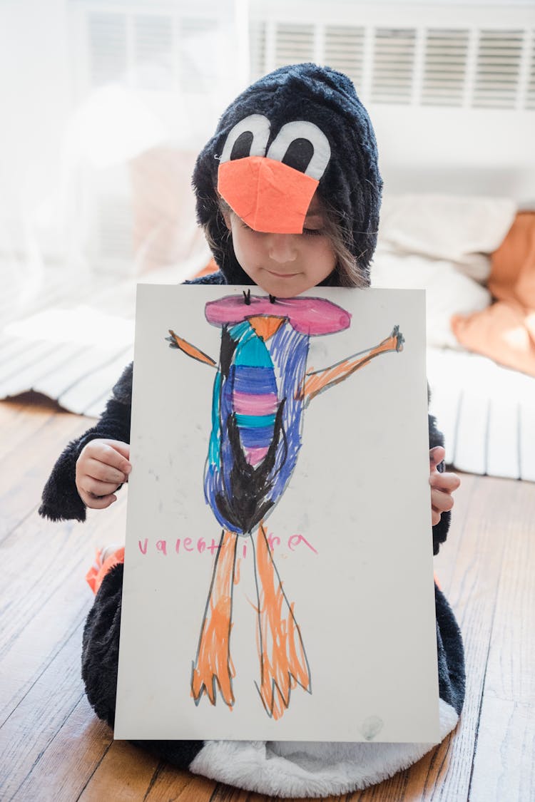 Girl In Black Animal Costume Holding A Drawing 