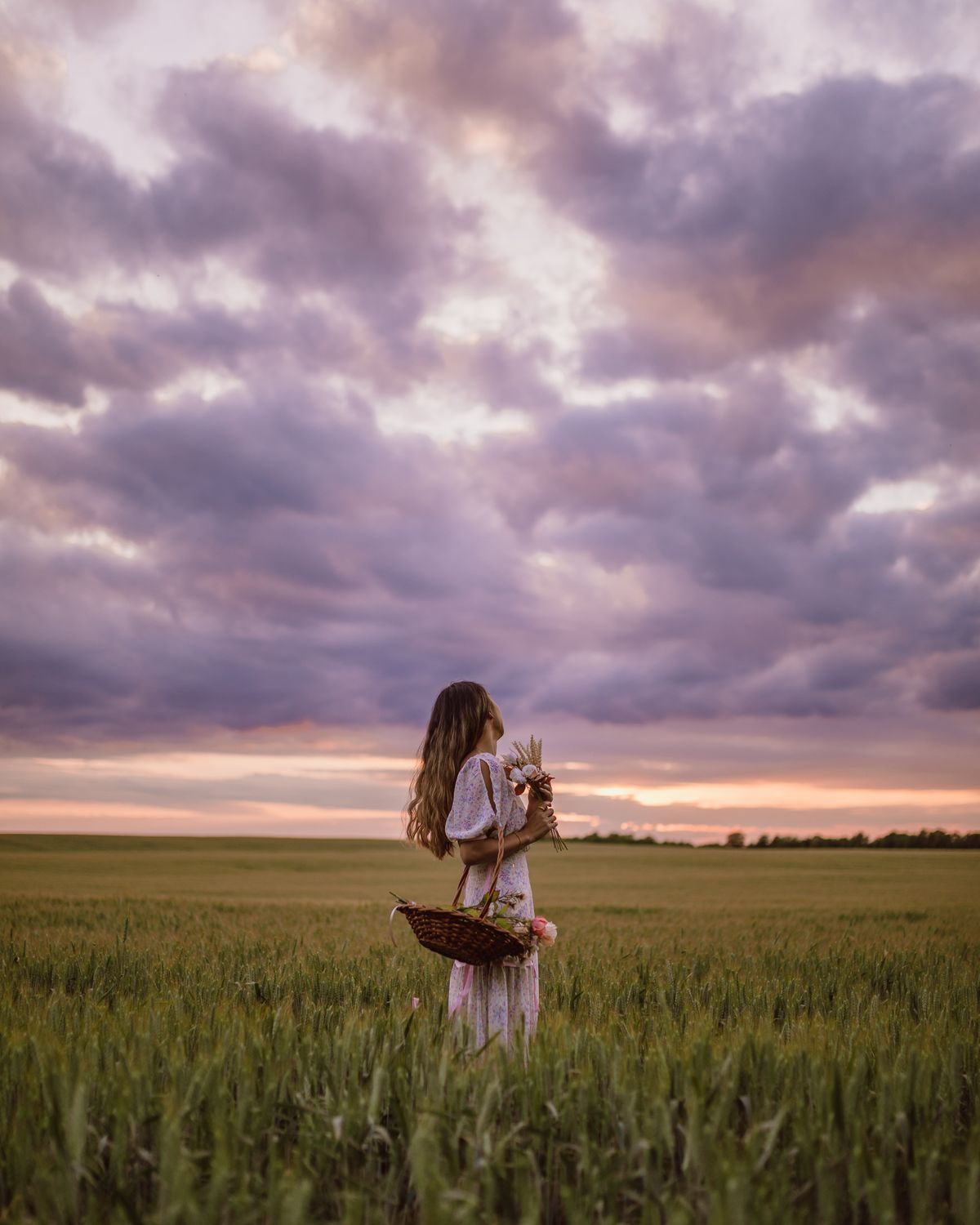 Young Woman in White Dress Holding Flowers While Standing in Wheat ...