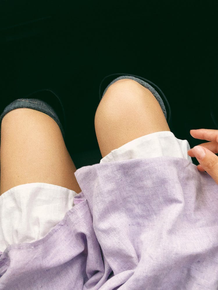 Woman's Knees With Purple Skirt