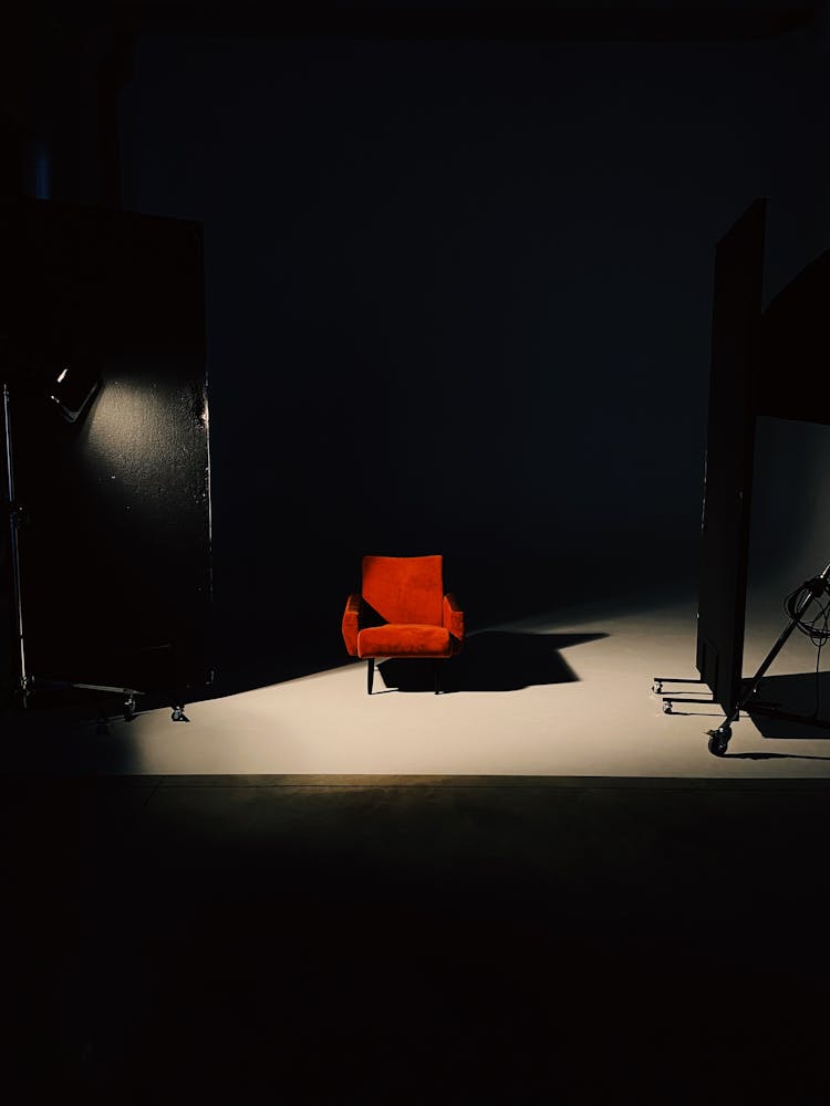 Red Chair On Spotlight Casting Shadow