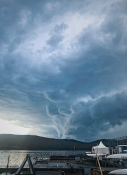 Dramatic stormy sky above a pier in Russkiy, Russia, showcasing an intense cloud formation.