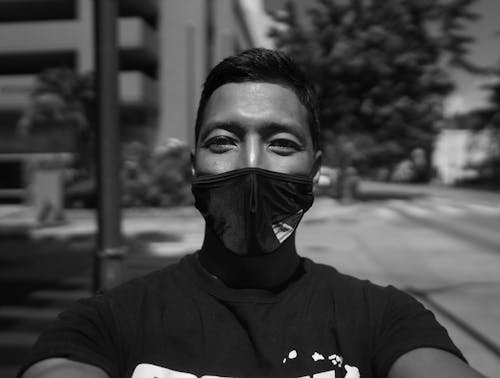 Grayscale Photo of a Man Wearing Face Mask