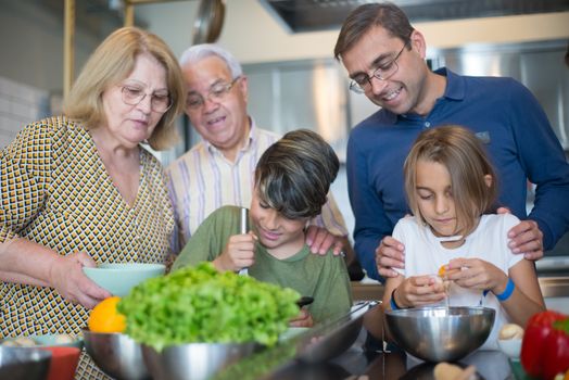 A joyful multi-generational family bonding while preparing a meal in the kitchen.