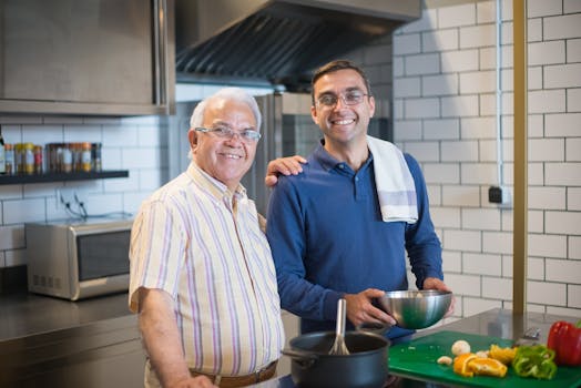 A joyful father and son duo cooking in a modern kitchen, showcasing family bonding and culinary skills.
