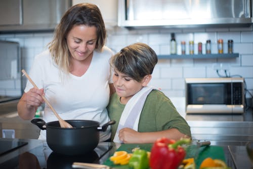 A Woman Cooking With His Son 