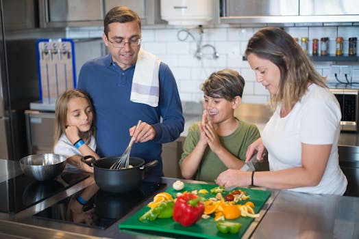 A happy family collaborates on a meal preparation in a stylish kitchen.