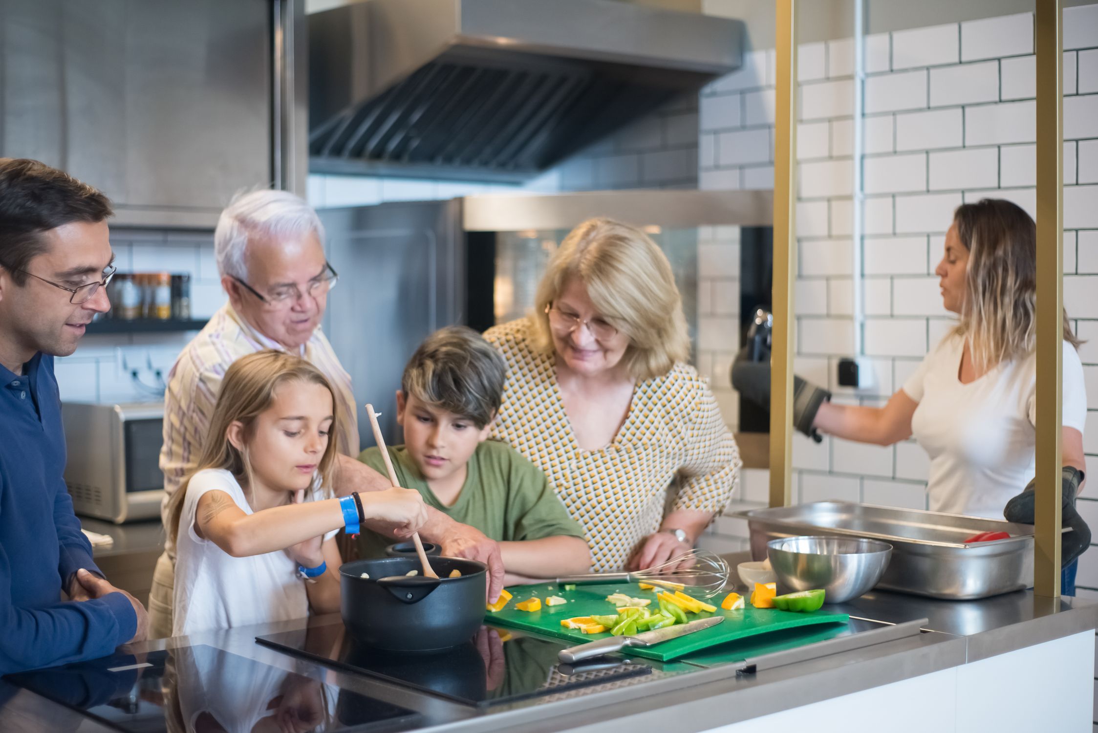 People in the Kitchen Looking at the Food the Little Girl is Cooking ...