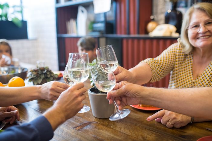 Guests raising glasses around a shared table — photo by Kampus Production on Pexels