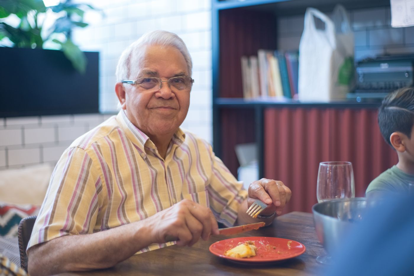 Smiling older man at a dinner table