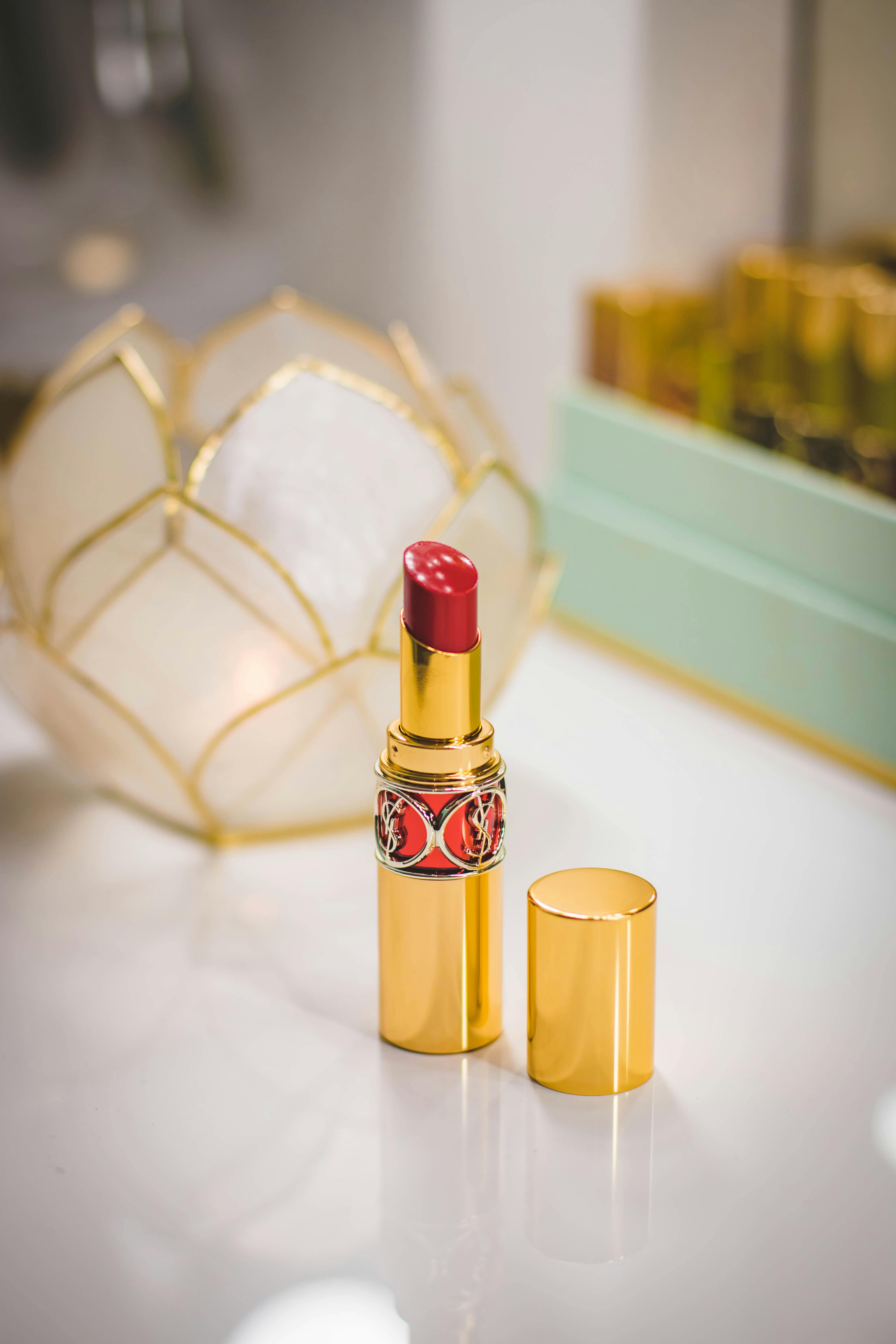 close up photography of red lipstick on desk