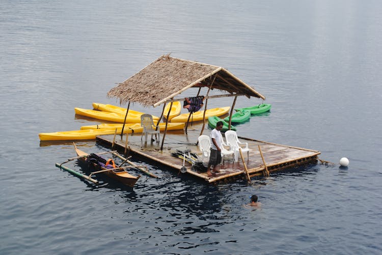 A Man Standing On The Raft