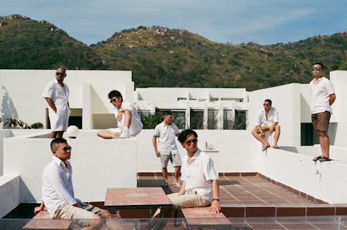 A Group of Men in White Long Sleeves and Shirts while Wearing Sunglasses