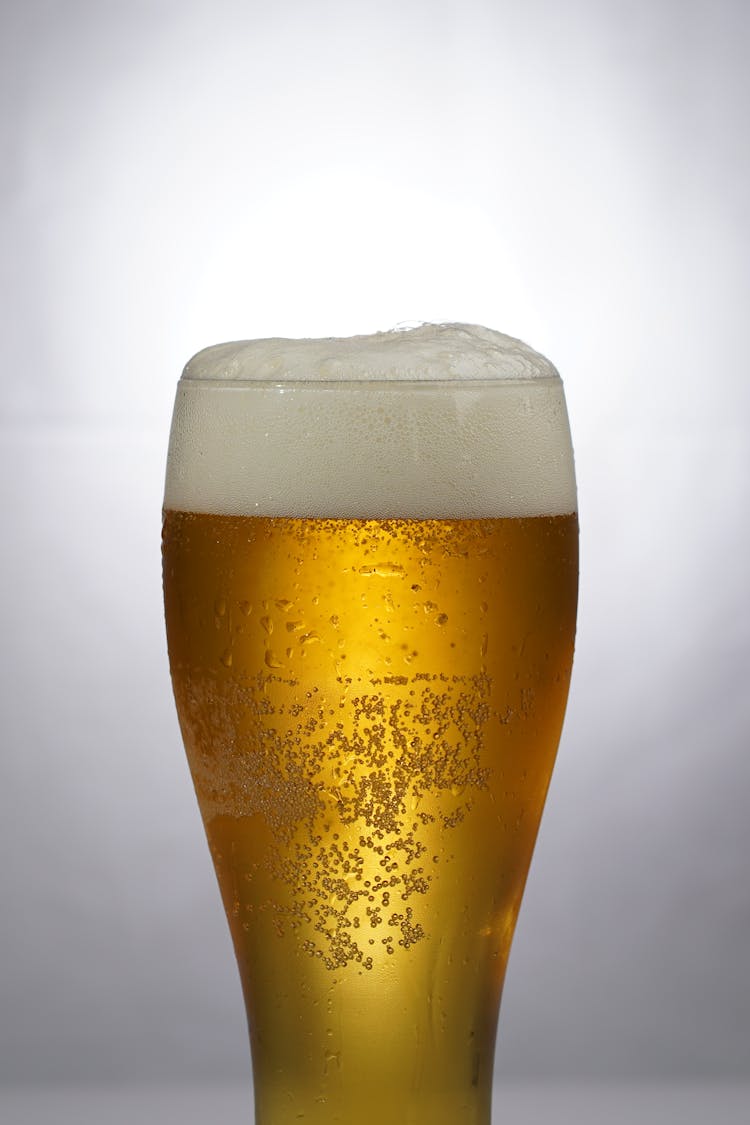 Clear Drinking Glass With Beer And Foam