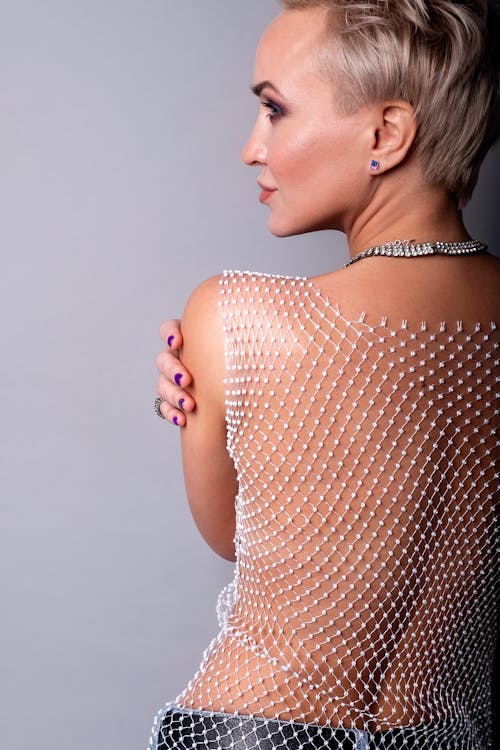 A Woman in See Through Tank Top Looking Over Shoulder