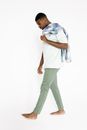 Man in White T-Shirt and Green Pants Stepping Up Barefoot