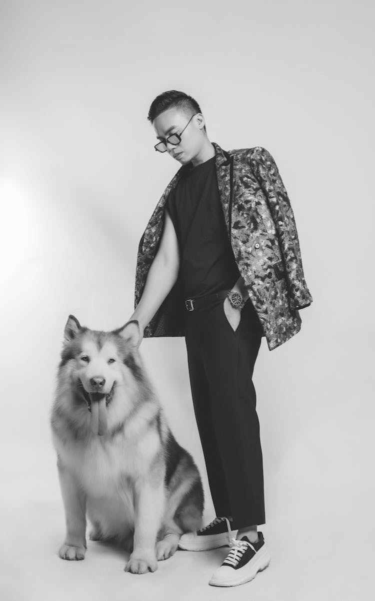 Fashionable Man Holding A Dog