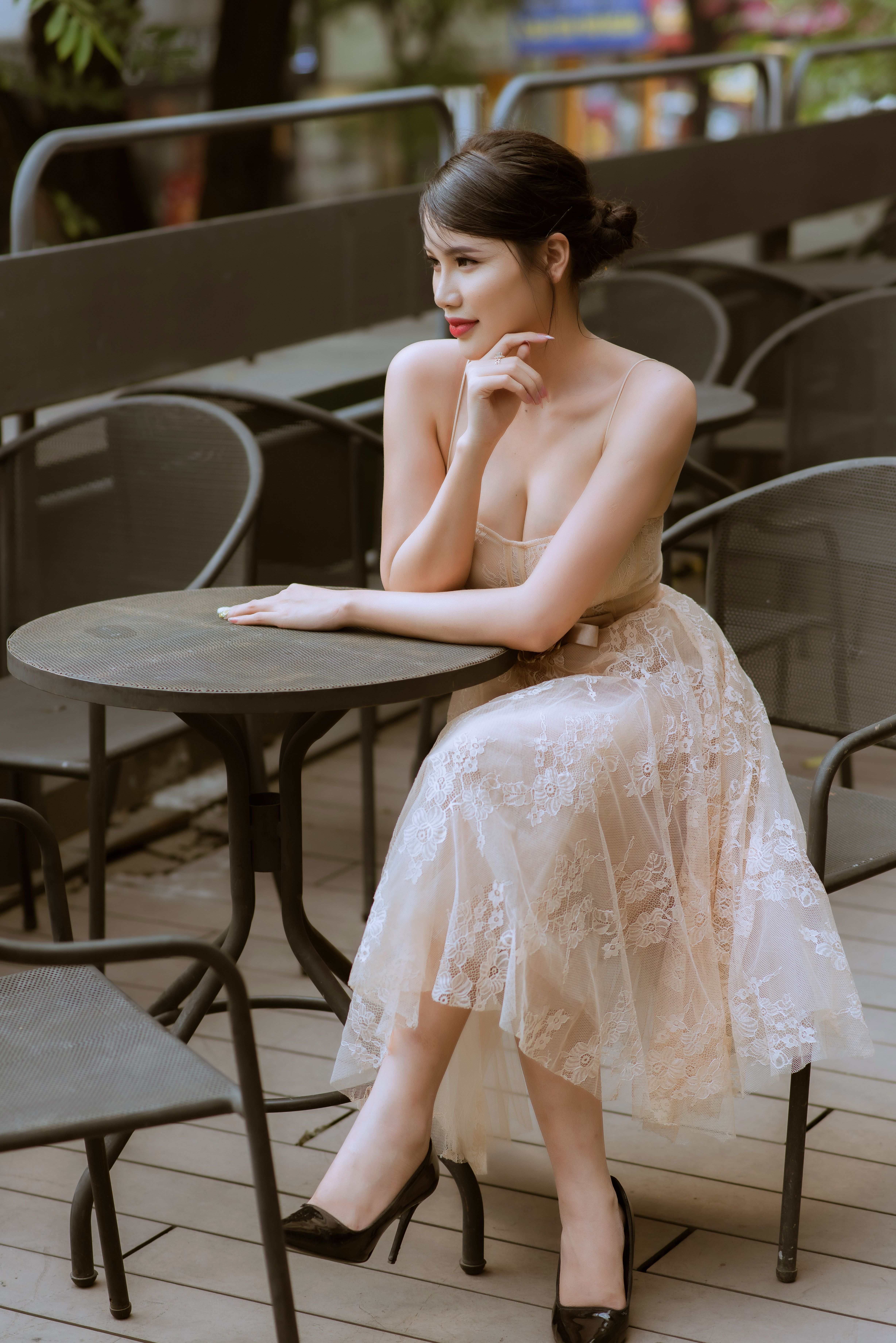 A Beautiful Woman in a Beige Dress Wearing Black High Heels  Free Stock  Photo