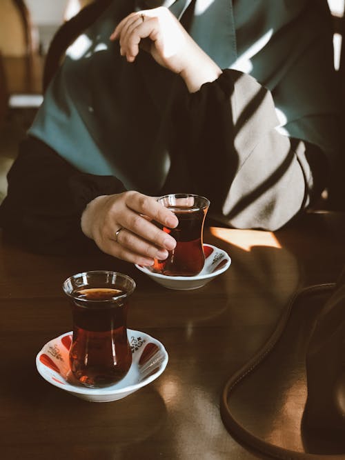 Close-Up Shot of a Person Holding a Glass of Liquor