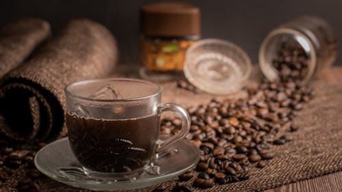 A Clear Glass Cup on Saucer with Black Coffee