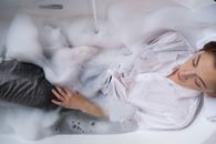 A Woman Soaking on a Bubble Bathtub