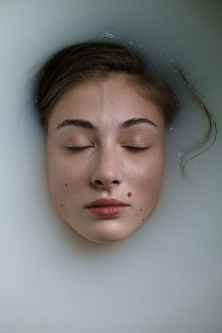 A Woman's Face On Milk Bath